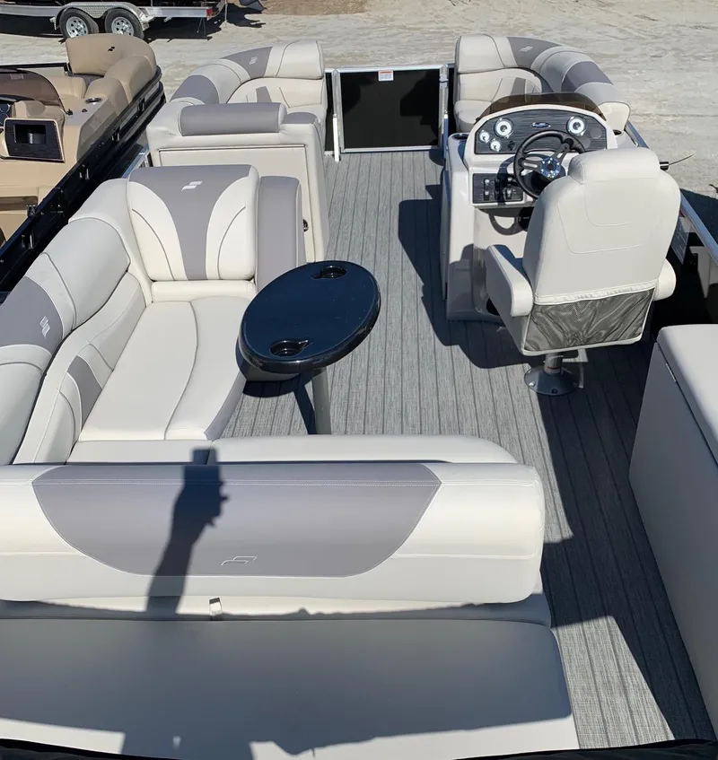 Slide: The Image of 2024 Starcraft EX22Q pontoon boat with spacious seating and modern helm. - 2