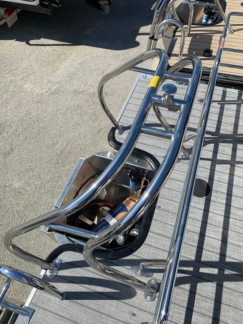 Slide: The Image of 2024 Starcraft EX22Q pontoon boat with stainless steel railings and deck. - 4