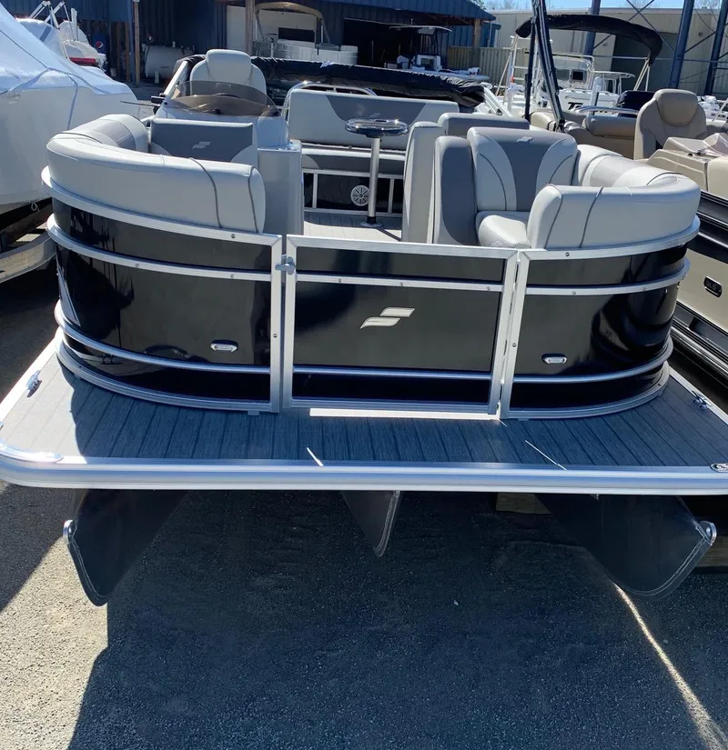 Slide: The Image of 2024 Starcraft EX22Q pontoon boat with sleek black exterior and spacious seating. - 1