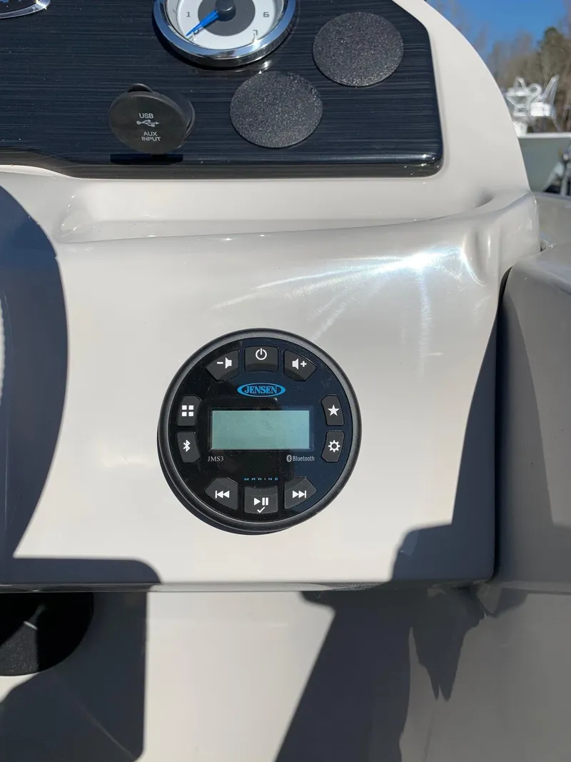 Slide: The Image of 2024 Starcraft EX22Q boat dashboard with control panel and gauge. - 12