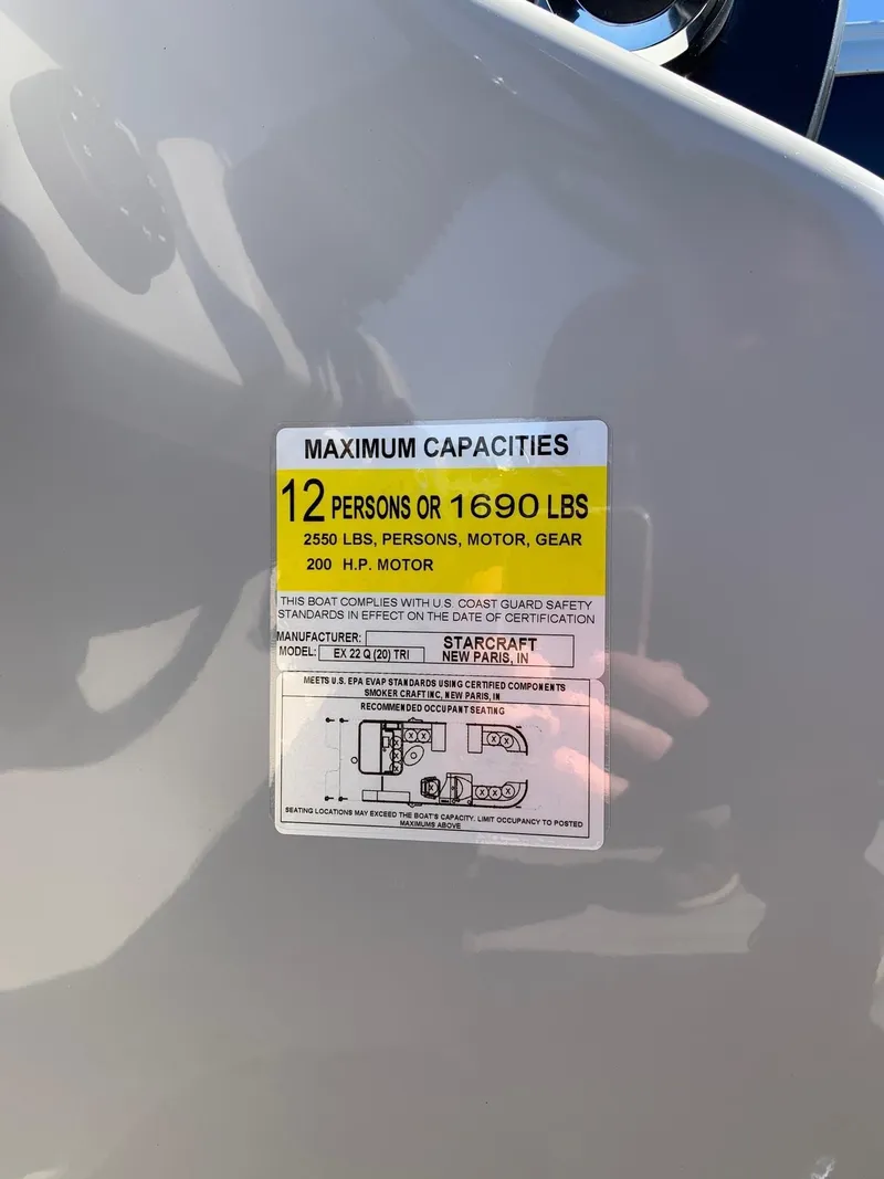 Slide: The Image of 2024 Starcraft EX22Q boat capacity label, maximum 12 persons or 1690 lbs, 200 HP motor. - 15