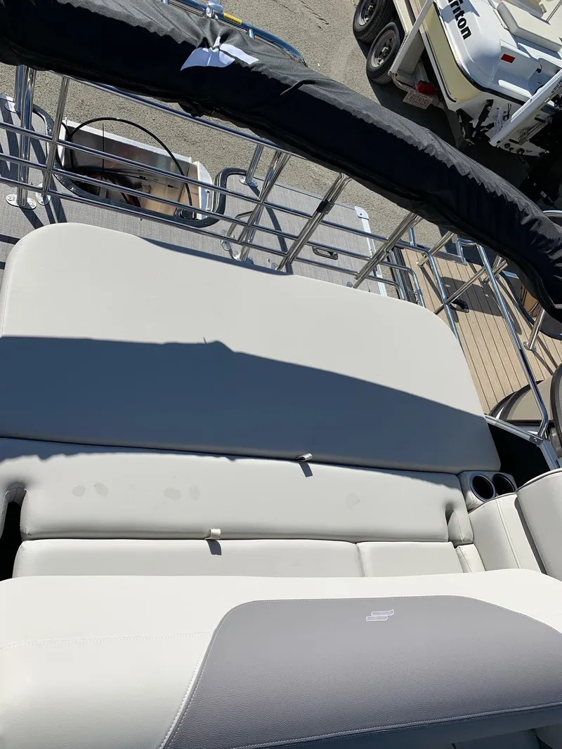 Slide: The Image of 2024 Starcraft EX22Q boat interior with cushioned seating. - 5