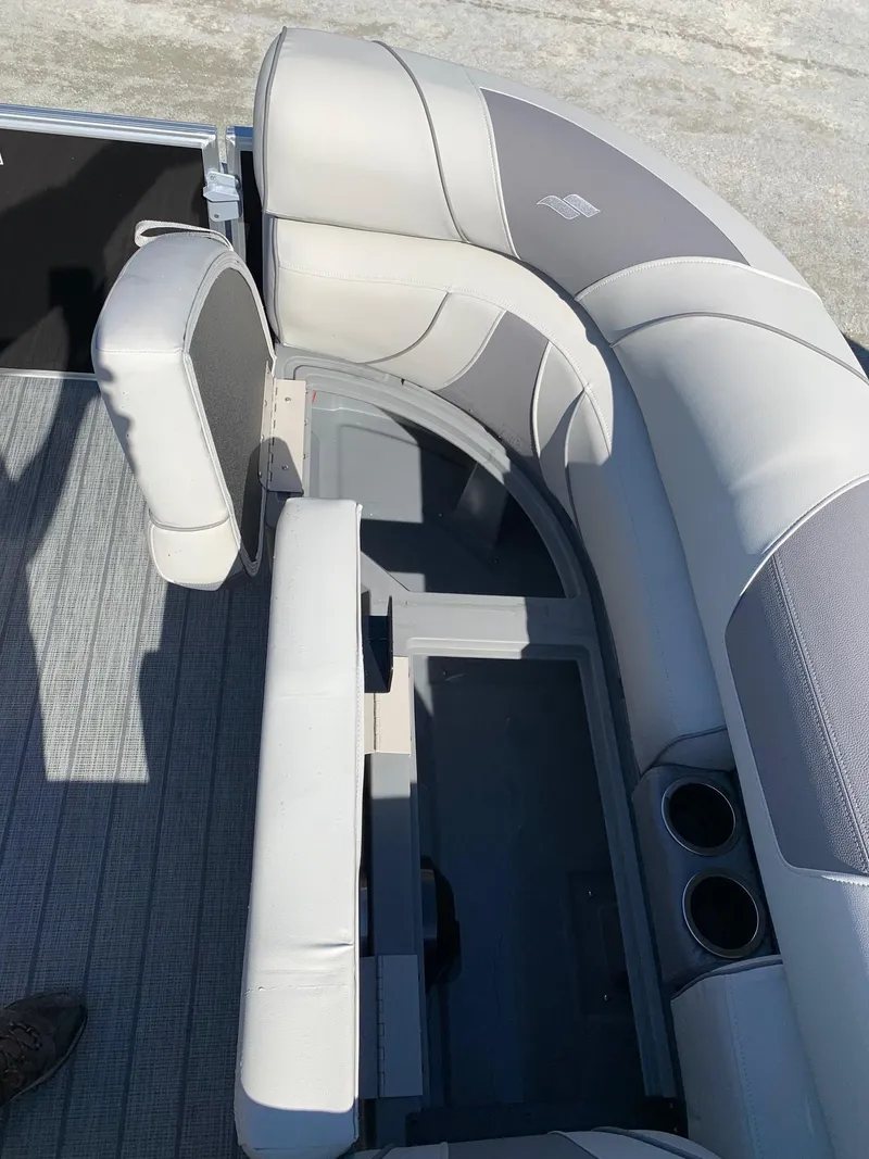 Slide: The Image of 2024 Starcraft EX22Q boat interior seating with storage compartment. - 8