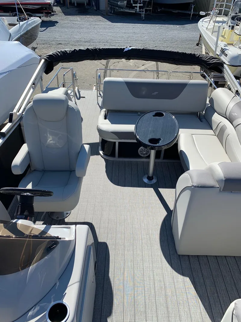 Slide: The Image of 2024 Starcraft EX22Q pontoon boat interior with seating and table. - 9