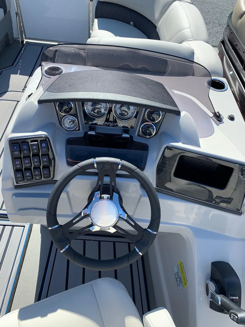 Slide: The Image of 2024 Starcraft SLS3 boat dashboard with steering wheel and control panel. - 11