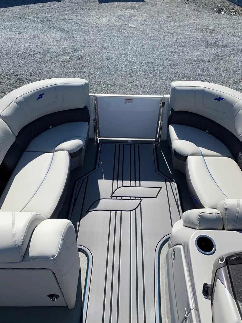Slide: The Image of 2024 Starcraft SLS3 pontoon boat interior with plush seating and modern flooring. - 5
