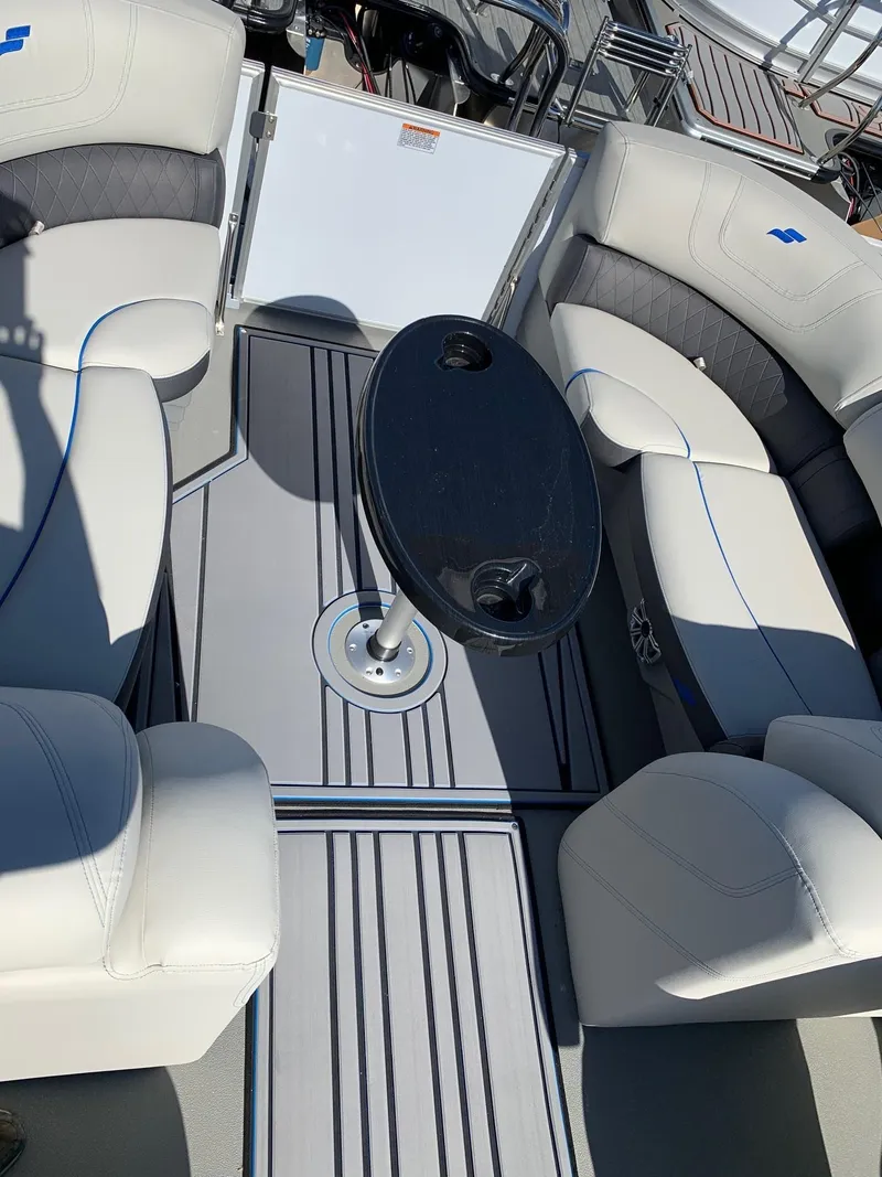 Slide: The Image of 2024 Starcraft SLS3 boat interior with plush seating and a central table. - 9