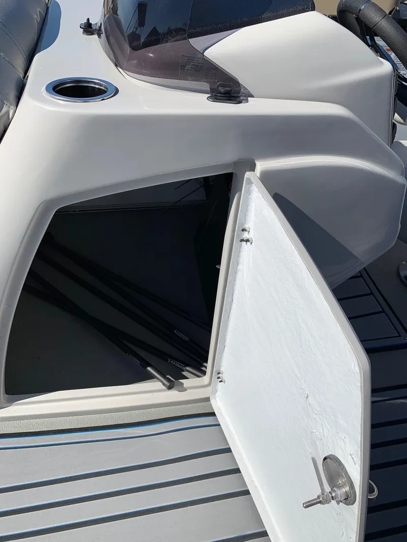 Slide: The Image of 2024 Starcraft SLS3 boat storage compartment with open door. - 12