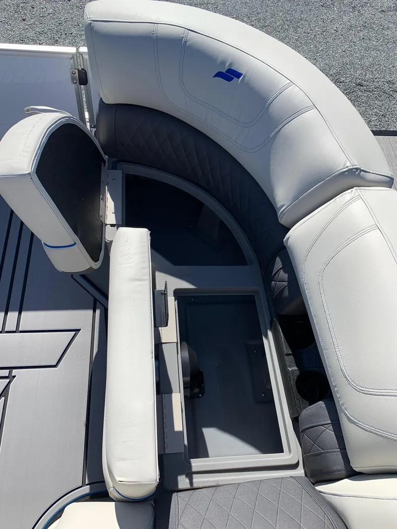 Slide: The Image of 2024 Starcraft SLS3 boat interior with white cushioned seating and storage compartment. - 6