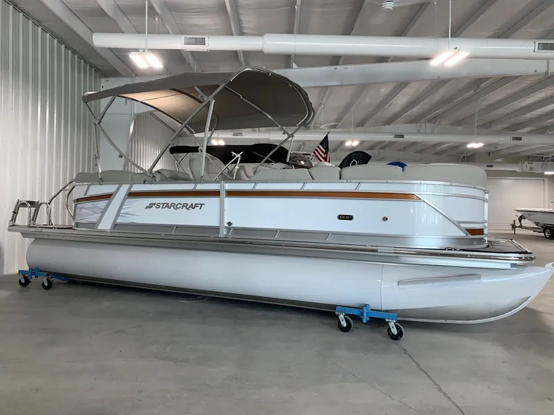 The Image of 2026 Starcraft SLS3 pontoon boat in indoor storage facility. - 0
