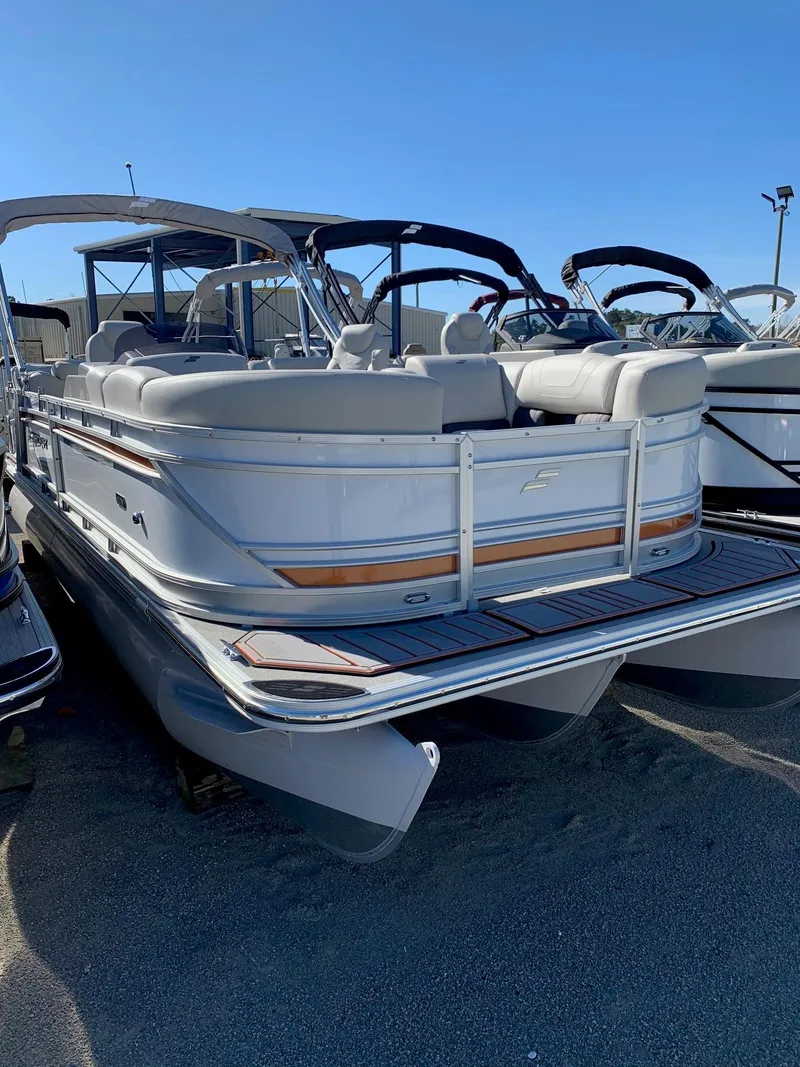 Slide: The Image of 2024 Starcraft SLS3 pontoon boat with sleek design and spacious seating. - 1