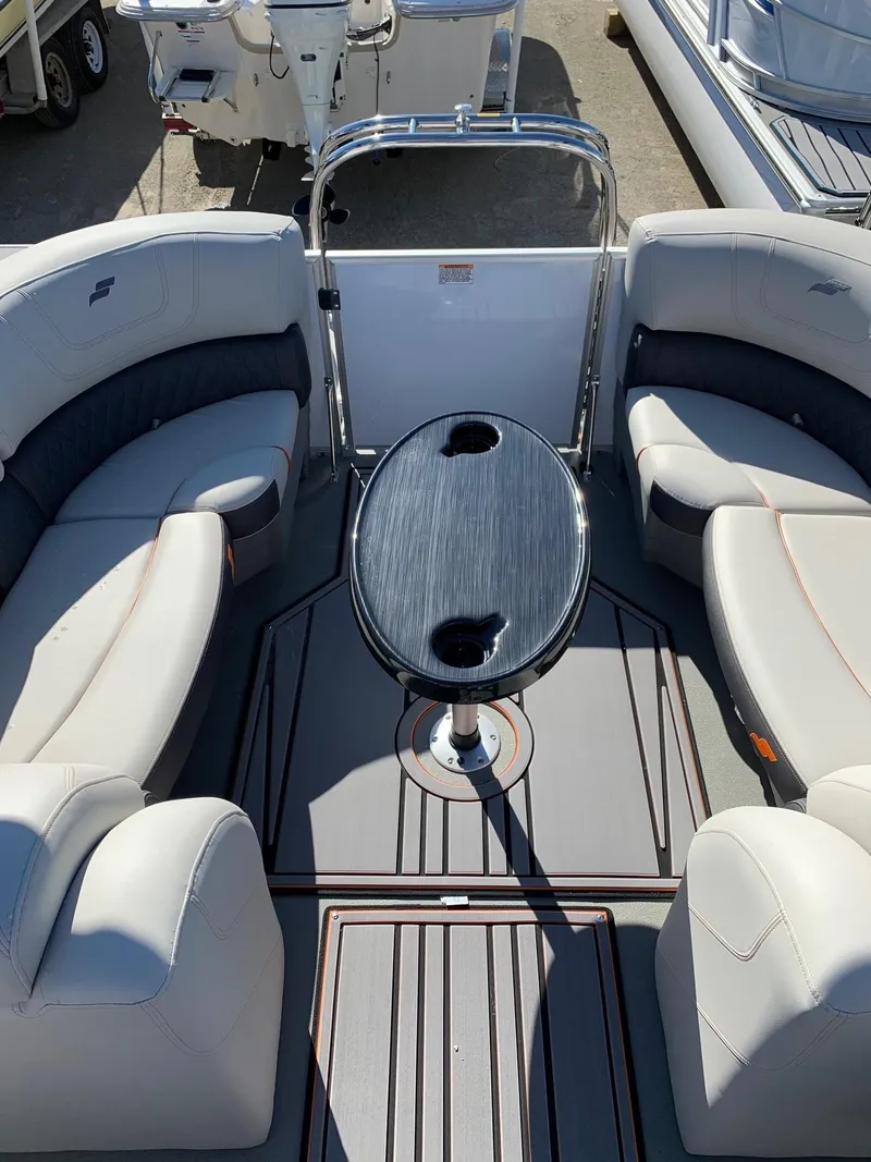 Slide: The Image of 2024 Starcraft SLS3 boat interior with cushioned seating and oval table. - 13