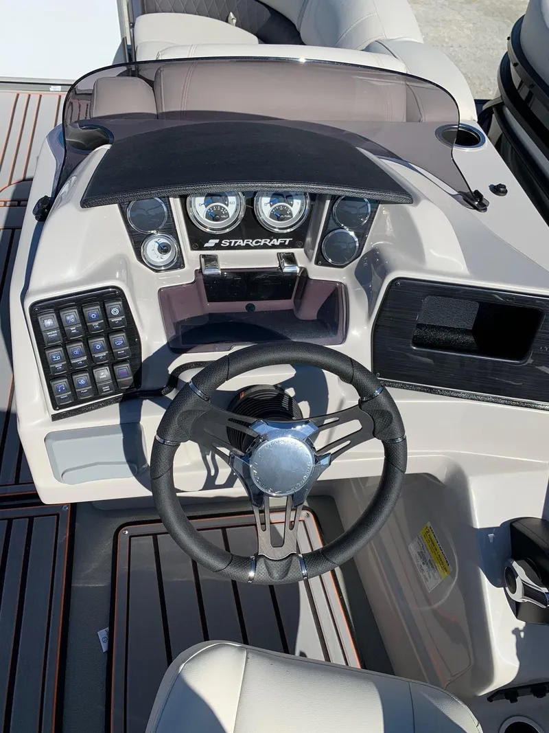 Slide: The Image of 2024 Starcraft SLS3 boat dashboard with steering wheel and control panel. - 14