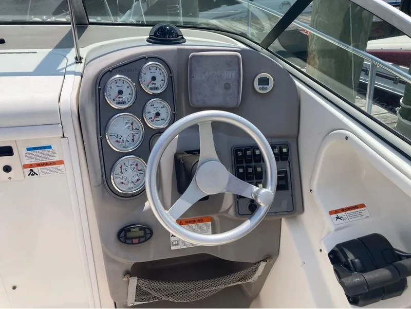 Slide: The Image of 2004 Wellcraft 252 Coastal boat dashboard with steering wheel and gauges. - 10