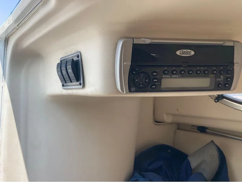 Slide: The Image of Clarion stereo system and control switches in a 2004 Wellcraft 252 Coastal boat. - 13