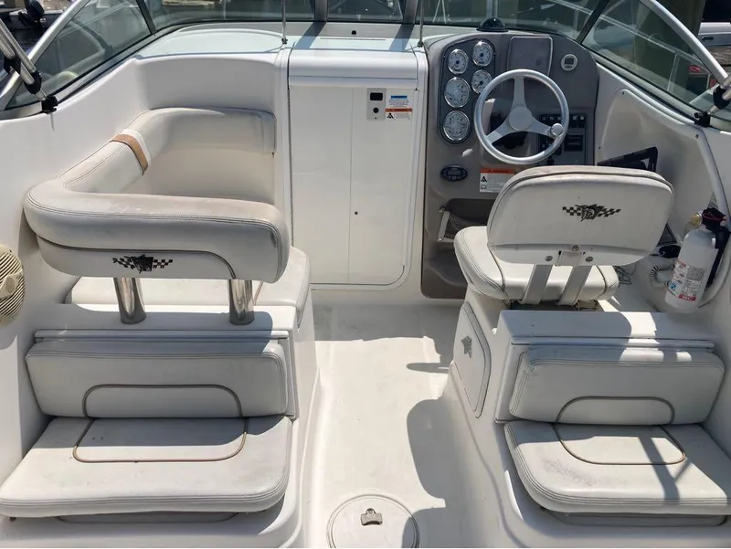 Slide: The Image of 2004 Wellcraft 252 Coastal boat interior with helm, seating, and control panel. - 14