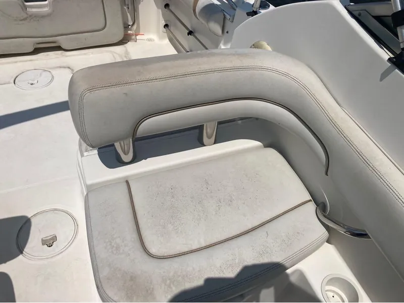 Slide: The Image of 2004 Wellcraft 252 Coastal boat seating area with white upholstery. - 6