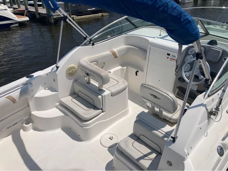 Slide: The Image of 2004 Wellcraft 252 Coastal boat interior with seating and steering wheel at marina. - 7