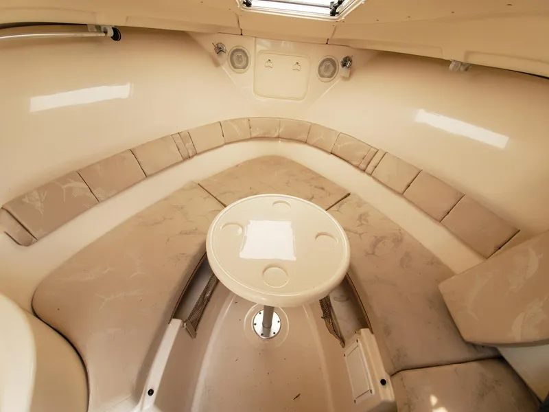 Slide: The Image of Interior cabin of a 2004 Wellcraft 252 Coastal boat with cushioned seating and table. - 9