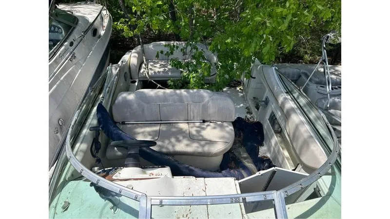 Slide: The Image of 2000 Monterey 242 Cruiser boat interior with seating and steering wheel. - 2