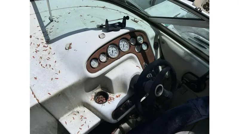 Slide: The Image of 2000 Monterey 242 Cruiser boat dashboard with gauges and steering wheel. - 4