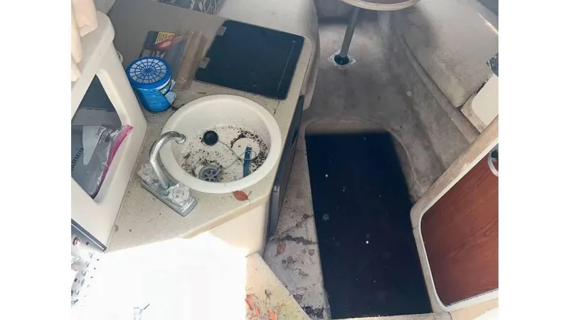 Slide: The Image of Interior of a 2000 Monterey 242 Cruiser boat showing sink and cabin area. - 5