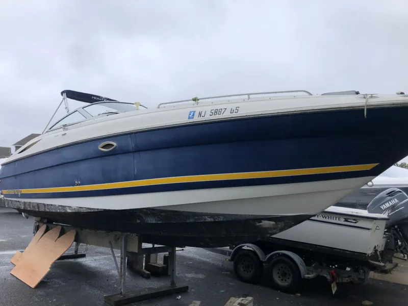 The Image of 2002 Monterey 298 SS boat on trailer, blue and white with yellow stripe. - 1