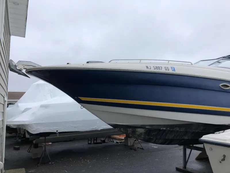 Slide: The Image of 2002 Monterey 298 SS boat in storage, side view with registration number NJ 5887 GS. - 3