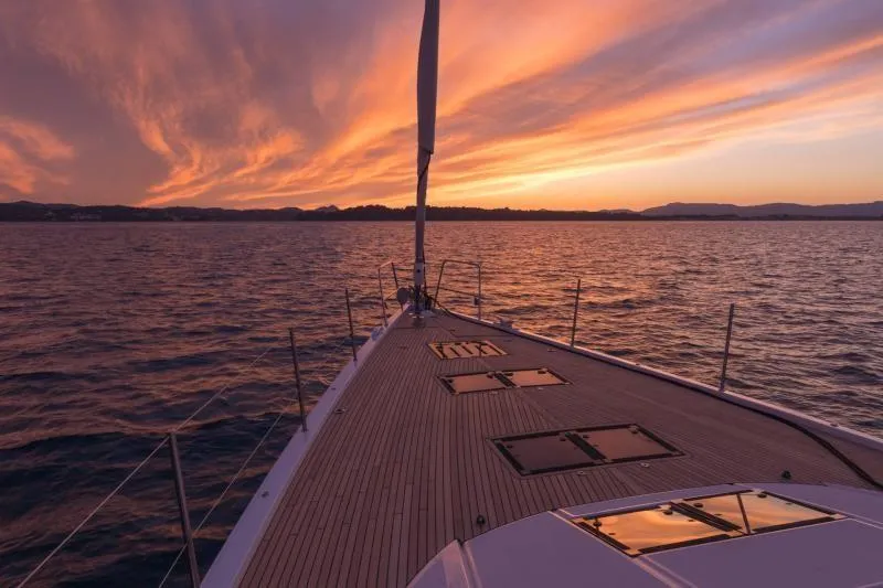 Slide: The Image of Jeanneau Yacht 65 sailing at sunset, 2025 model. - 1