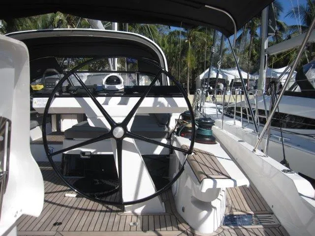 Slide: The Image of 2025 Jeanneau Yacht 65 cockpit with steering wheel and deck view. - 16