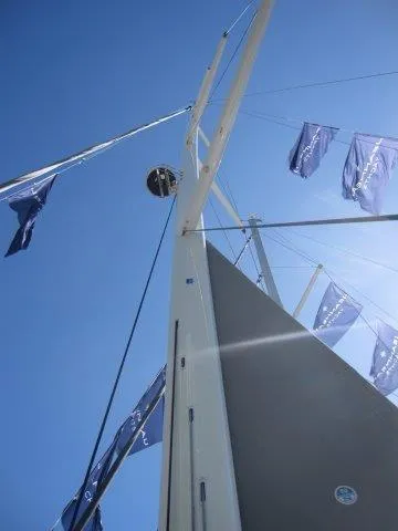 Slide: The Image of 2025 Jeanneau Yacht 65 mast and sails against blue sky. - 32