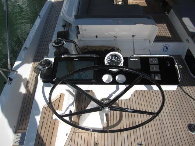 Slide: The Image of 2025 Jeanneau Yacht 65 steering wheel and navigation controls. - 37