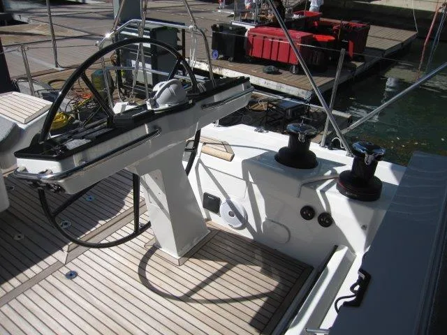 Slide: The Image of 2025 Jeanneau Yacht 65 cockpit with steering wheel and winches. - 42
