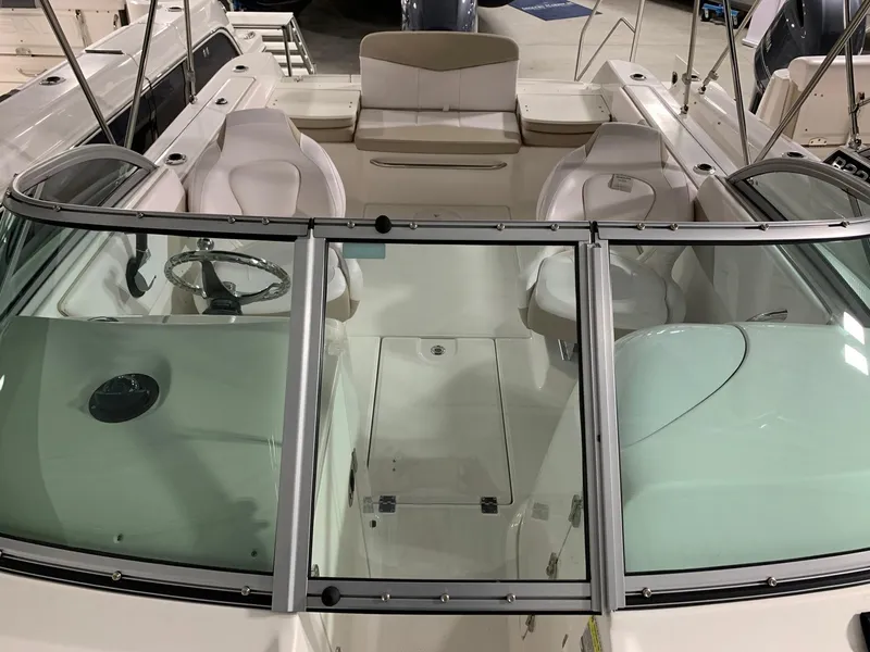Slide: The Image of 2024 Robalo R207 Dual Console boat interior with seating and windshield. - 14
