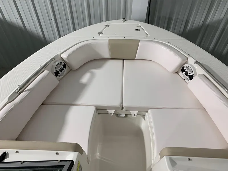 Slide: The Image of 2024 Robalo R207 Dual Console boat interior with white cushioned seating. - 18