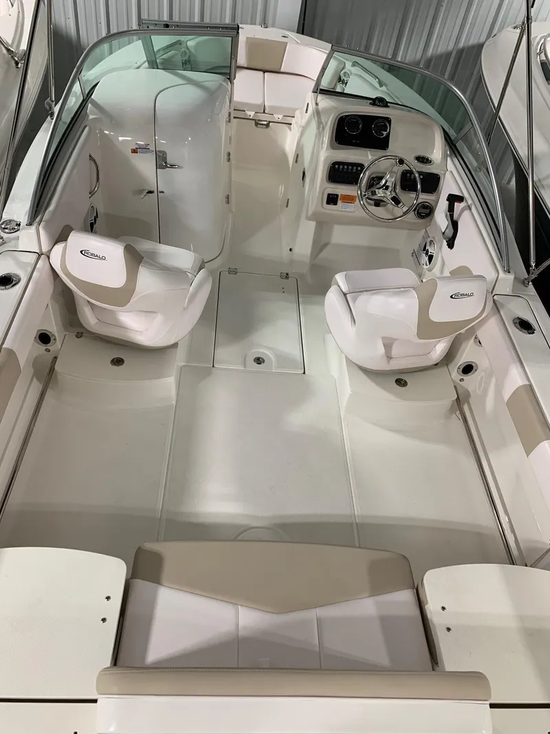 Slide: The Image of 2024 Robalo R207 Dual Console boat interior with seating and steering console. - 19