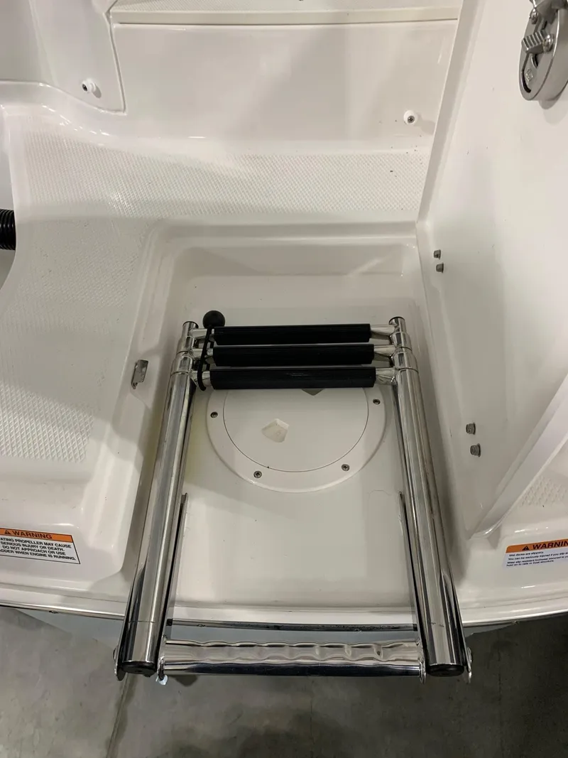 Slide: The Image of 2024 Robalo R207 Dual Console boat with a folded swim ladder. - 4