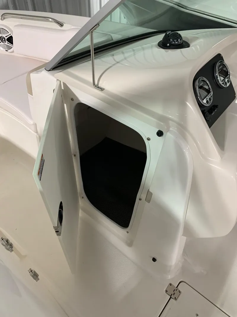 Slide: The Image of 2024 Robalo R207 Dual Console boat with open storage compartment. - 8