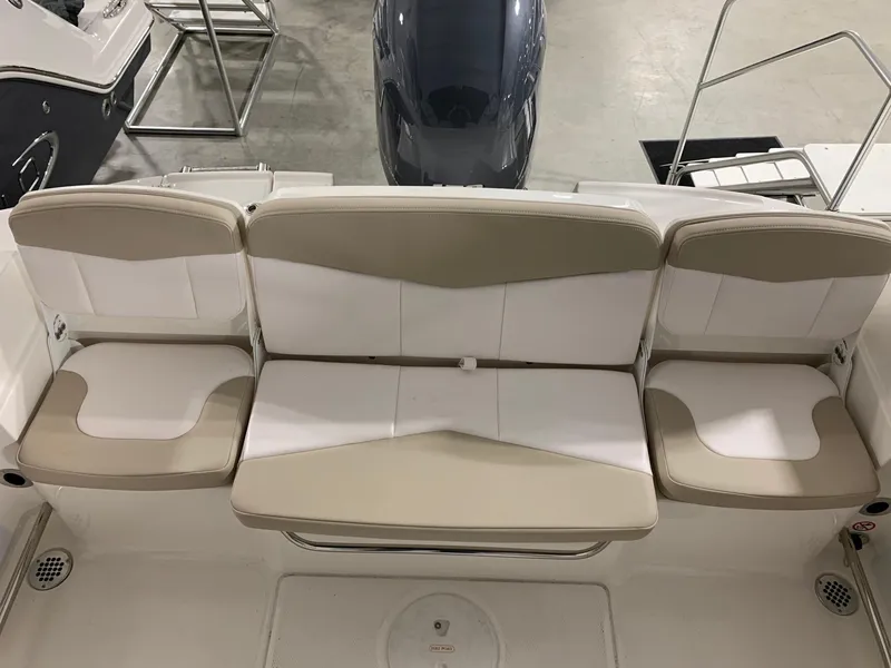 Slide: The Image of 2024 Robalo R207 Dual Console boat with beige and white seating. - 11