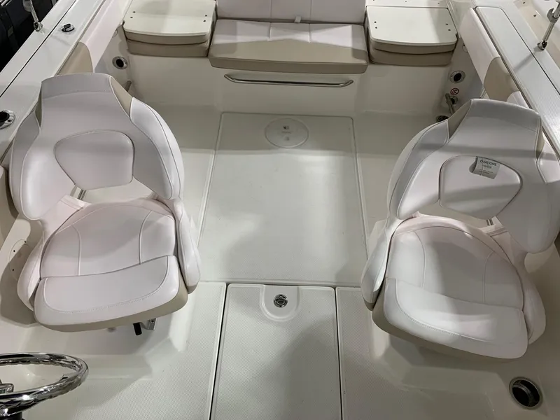 Slide: The Image of 2024 Robalo R207 Dual Console boat interior with white seating and spacious layout. - 13