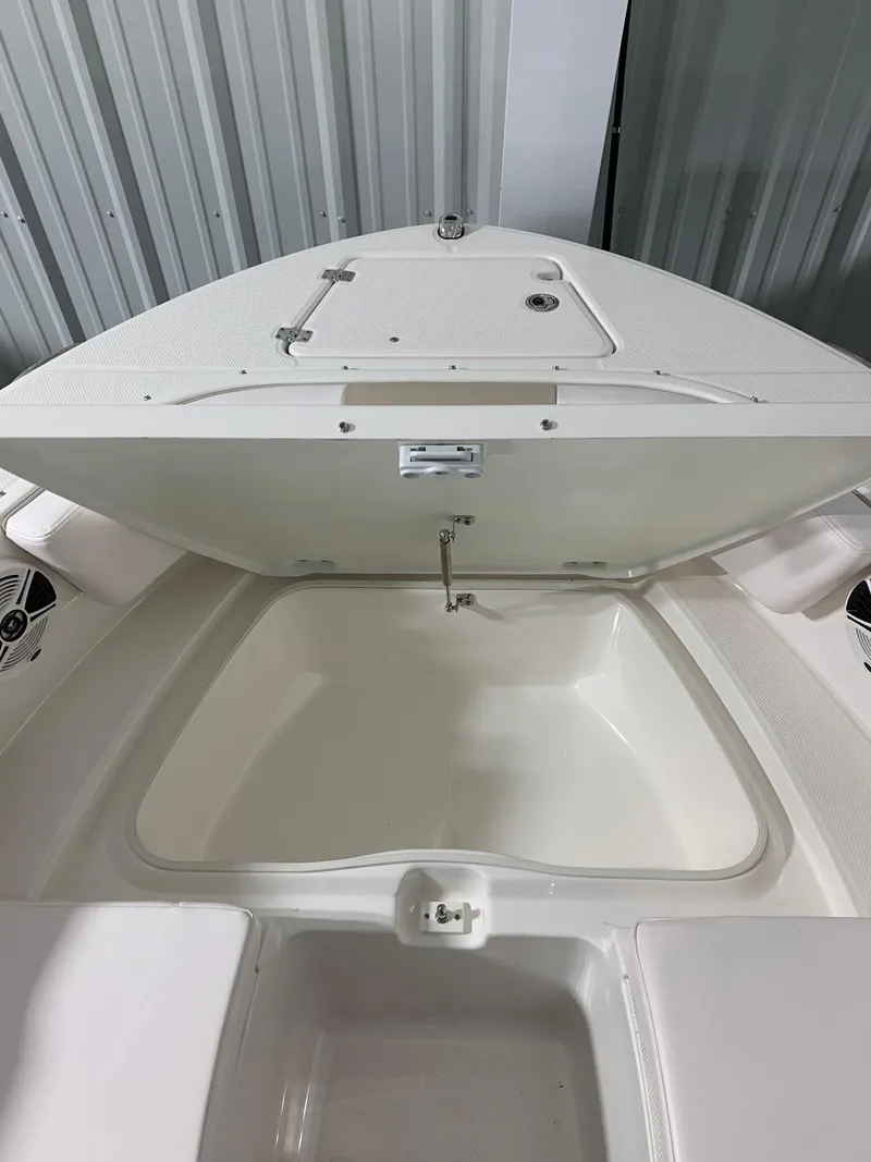 Slide: The Image of 2024 Robalo R207 Dual Console boat with open storage compartment. - 16