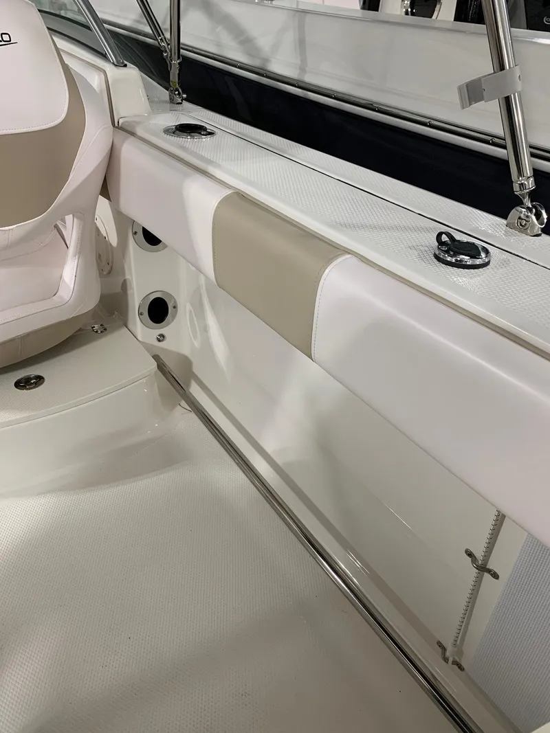 Slide: The Image of 2024 Robalo R207 Dual Console boat interior, white and beige seating. - 5