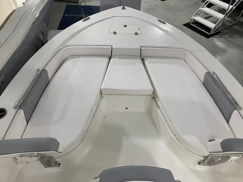 Slide: The Image of 2024 Robalo 206 Cayman boat with white cushioned seating in the bow area. - 10