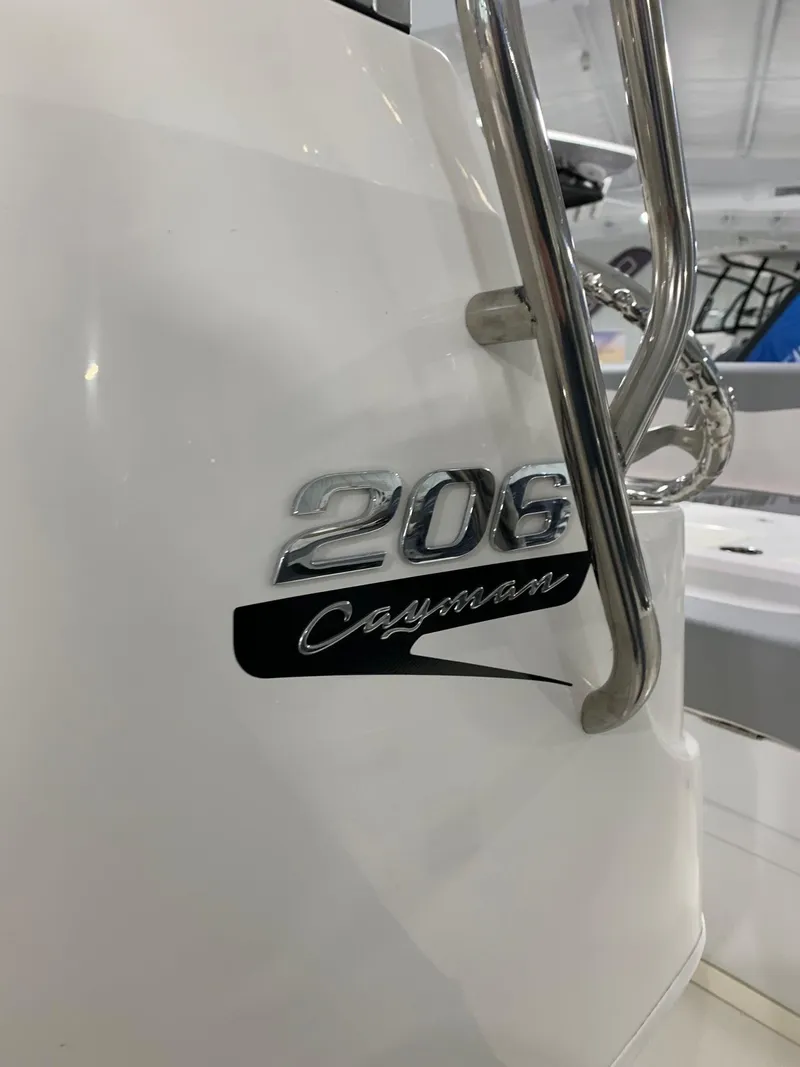 Slide: The Image of 2024 Robalo 206 Cayman boat model emblem and stainless steel railing. - 11