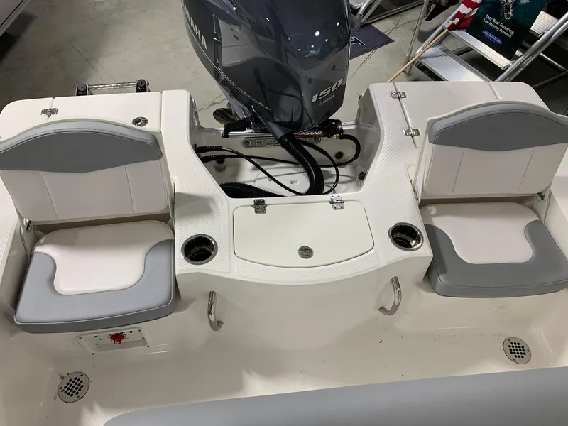 Slide: The Image of 2024 Robalo 206 Cayman boat interior with seating and Yamaha 150 engine. - 17