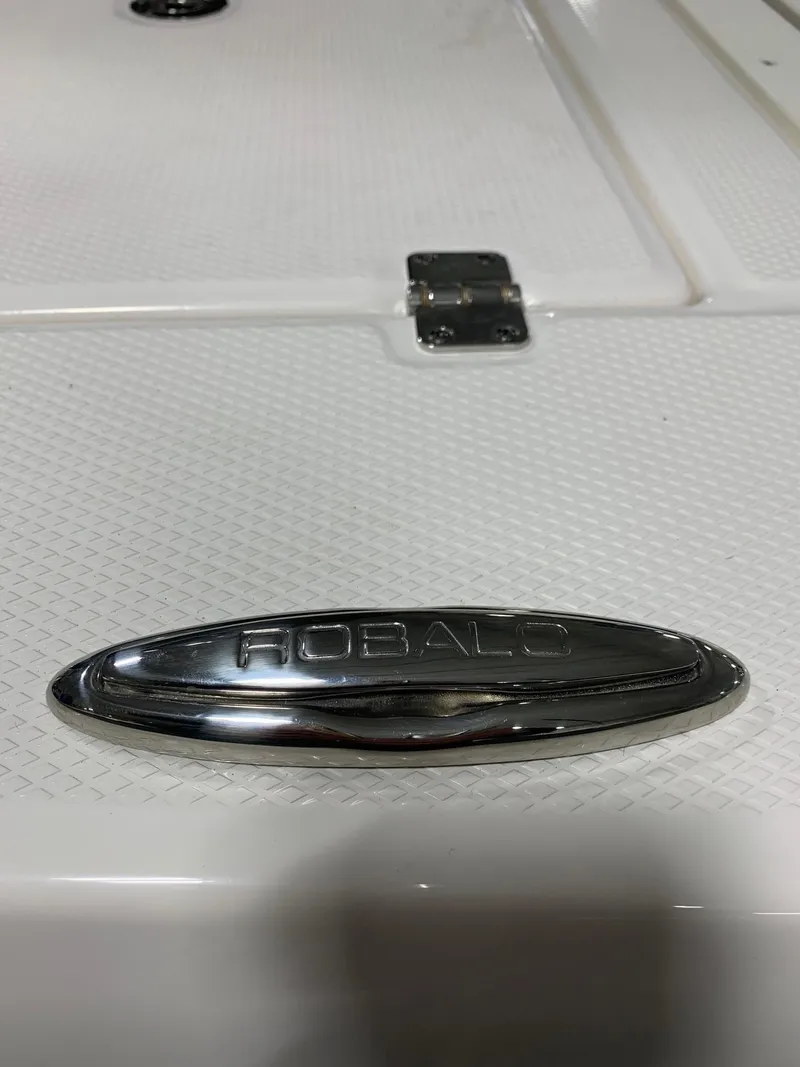 Slide: The Image of 2024 Robalo 206 Cayman boat logo on white textured surface. - 5