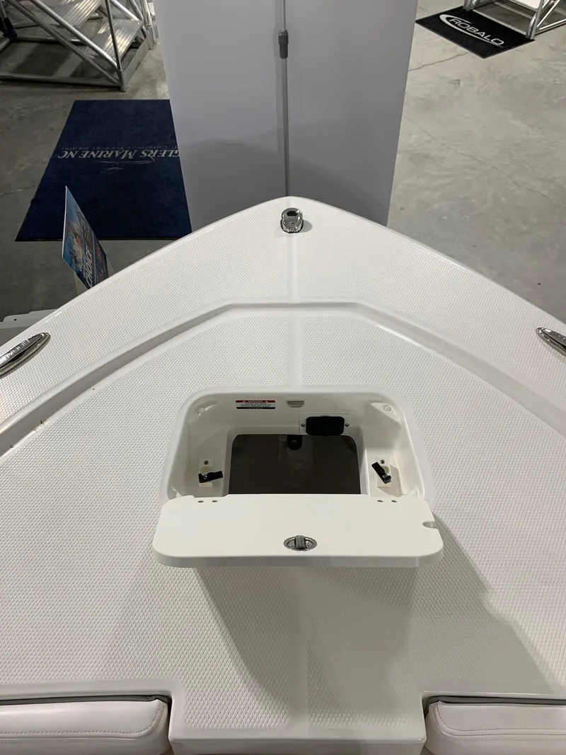 Slide: The Image of 2024 Robalo 206 Cayman boat bow with open storage compartment. - 8