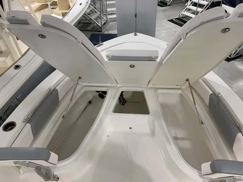 Slide: The Image of 2024 Robalo 206 Cayman boat with open storage compartments. - 9