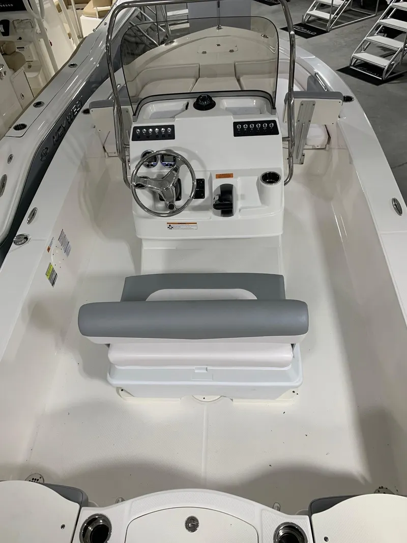 Slide: The Image of 2024 Robalo 206 Cayman center console boat interior with steering wheel and seating. - 19