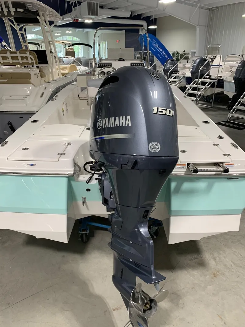 Slide: The Image of 2024 Robalo 206 Cayman with Yamaha 150 outboard motor in showroom. - 3